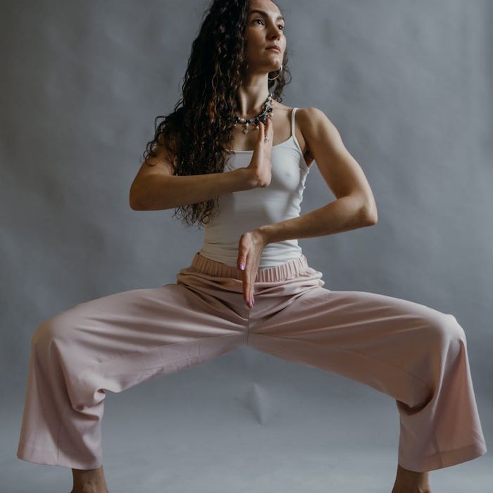 Person in a dynamic yoga pose showing flexibility and strength.